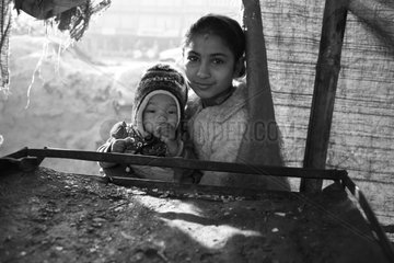 Young girl and baby in a canvas Kathmandu Nepal