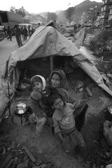 Family eating outside his tent in the street Kathmandu Nepal