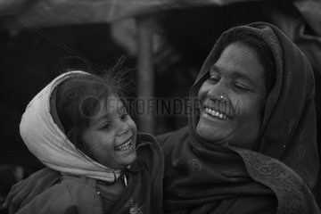 Woman in the streets and his daughter smiling Kathmandu Nepal