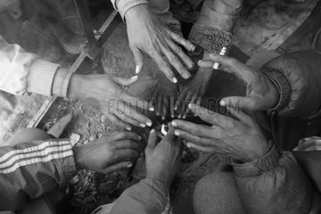 Hands of men warming Kathmandu Nepal