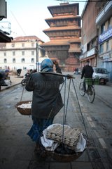 Woman carrying baskets of eggs in Kathmandu Nepal