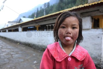 Portrait of girl pulling the tongue Chame Nepal