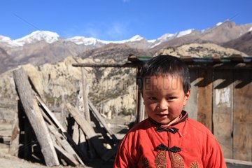 Portrait of boy and mountain Humde Himalaya Nepal