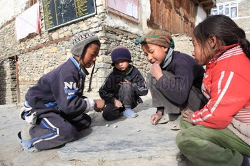 Children playing with pebbles Manang Nepal Himalayas