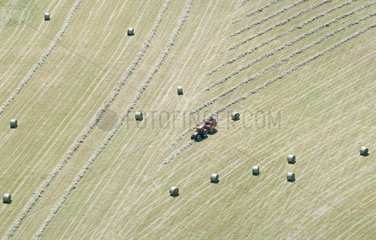 Pressing the round bales in the hay France