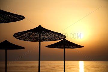 Umbrellas at sunrise by the sea Turkey