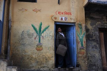 Man in suit out of a house painted Varanasi India