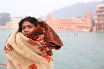 Man in a blanket on the banks of Ganges Haridwar India