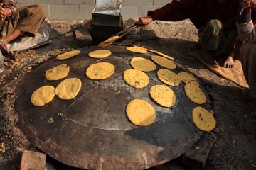 Cooking chapattis on tawa Haridwar India