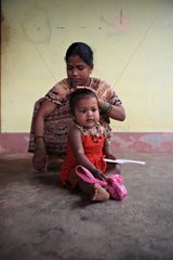 Woman styling her daughter Gokarna India