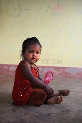 Young girl wearing a red dress Gokarna India