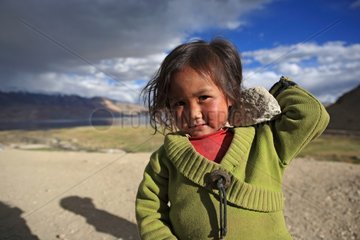 Girl and stone Lake Tso Moriri Ladakh Himalayas India