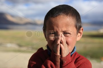 Boy saluting Lake Tso Moriri Ladakh Himalayas India