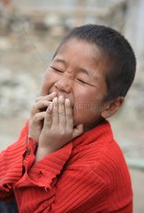 Boy laughing Moriri Tso Lake Ladakh Himalayas India