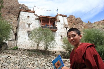 Young monk and monastery Hemis Ladakh Himalayas India