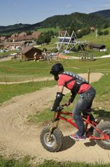 Downhill scootering on the ski slopes in summer Jura