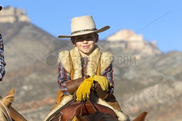 Young cowboy on his Quarter Horse in the Wyoming USA
