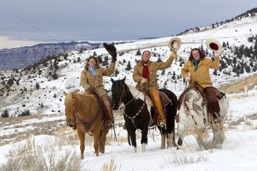 Cowboys on their Quarter Horse saluting Wyoming USA