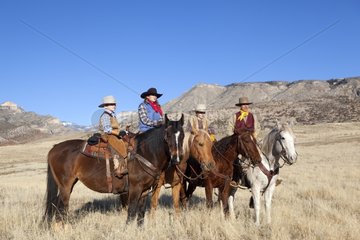 Family of cowboys riding together in Wyoming USA