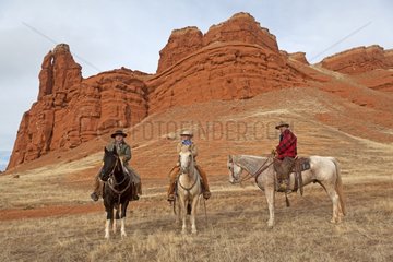 Cowboys on their Quarter Hose in winter Wyoming USA
