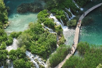 Tourists on wooden footbridge PN Plitvice Lakes Croatia