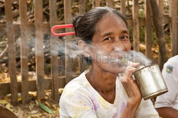 Smoking a Burmese cigar at the Manisitu Market Burma