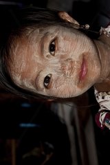 A little girl at the Silk Weaving factory Inle Lake Burma