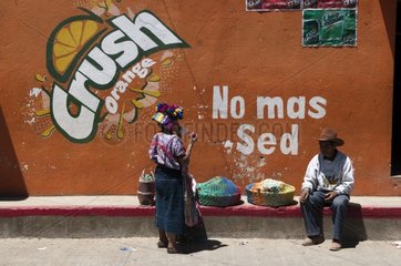 People in front of a fruit drink advertising Guatemala