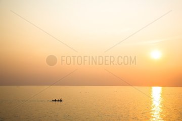 Boat and sunset on Lake Tonle Sap Cambodia