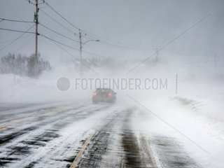 Snow sweeping the road during a storm Canada