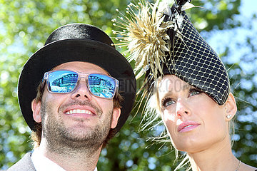Royal Ascot  Fashion on Ladies Day  woman with hat and man with top hat at the racecourse