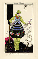 Woman in pea-green dress with embroidered satin skirt.