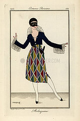 Woman in harlequin costume and mask for a fancy dress ball.