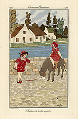 Two children in printed toile summer outfits with a donkey.