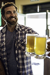 Smiling man toasting beer