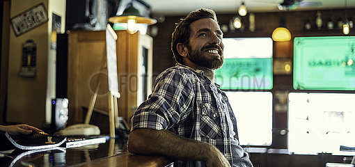 Man leaning against bar counter