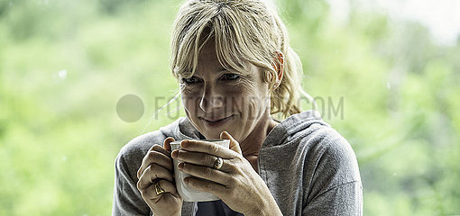 Mature woman having coffee