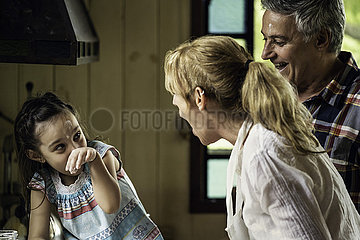 Girl with her grandparents in kitchen