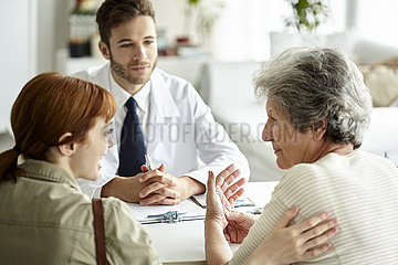 Mother and daughter talking in clinic