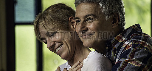 Couple embracing indoors