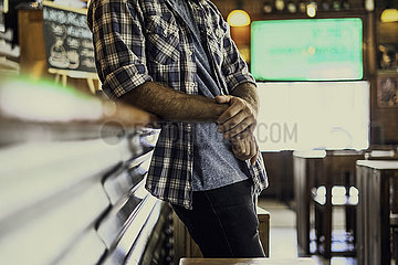Man leaning against bar counter