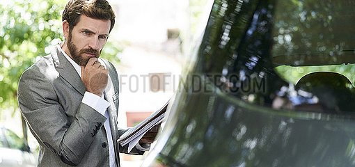 Man examining car