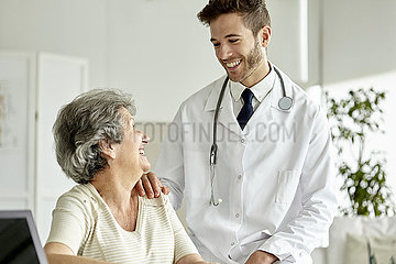 Doctor consoling senior woman