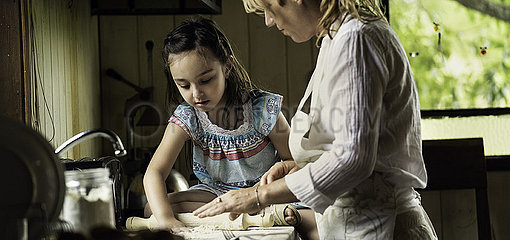Granddaughter and grandmother preparing food