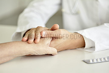 Close-up of doctor holding patient's hand