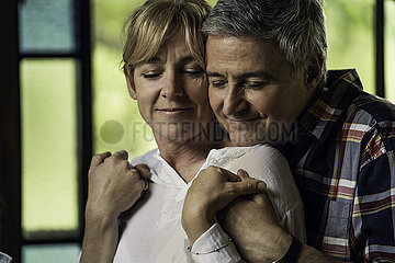 Couple embracing indoors