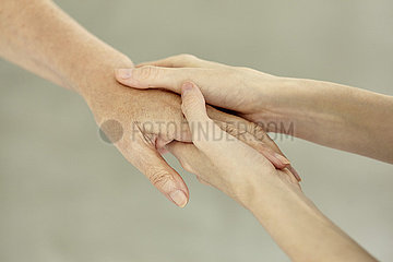 Nurse holding patient's hand