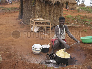 A woman cooks on an outside fire in Angola. Feeding centres and other humanitarian aid were organised in Angola after widescale malnutrition during and following the countrys civil war.