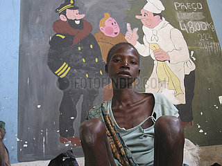A malnourished boy sits in front of a mural painting at the MSF feeding centre in Angola. Feeding centres and other humanitarian aid were organised in Angola after widescale malnutrition during and following the countrys civil war.