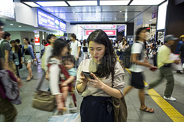 women on mobile phone in subway